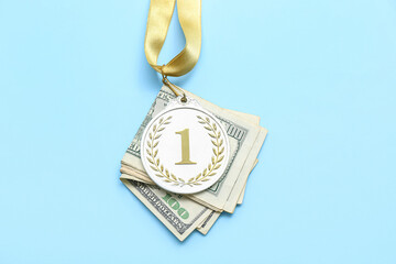 First place medal with money on blue background