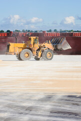 Payloader cleaning up the docks after shipment of raw sugar.