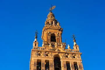 Fototapeta na wymiar View of La giralda the bell tower of the cathedral of Seville from the rooftop of the cathedral, It was originally built as the minaret for the Great Mosque of Seville in al-Andalus, Moorish Spain