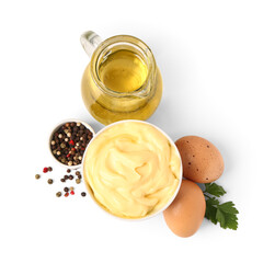 Bowl with tasty mayonnaise sauce and ingredients on white background
