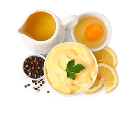 Bowl with tasty mayonnaise sauce and ingredients on white background