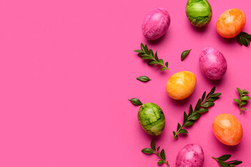 Composition with Easter eggs and plant leaves on pink background