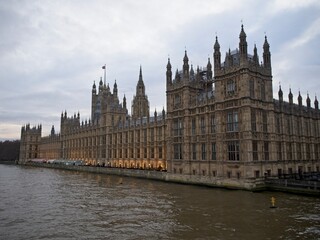 Fototapeta na wymiar The Houses of Parliament line the River Thames