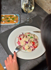 Overhead view of delicious vitel tonne served with sauce and cherry tomatoes in elegant Italian restaurant, healthy food, copyspace