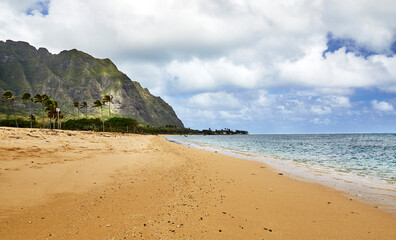 Shore line view of ocean with Koolau mountains in the background