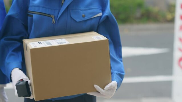 Delivery staff delivering packages to home.