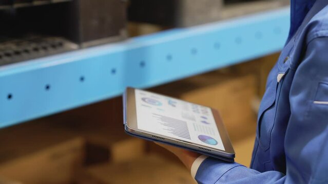 Worker looking at data on a tablet.
