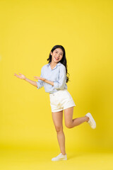 full body image of beautiful asian girl, isolated on yellow background