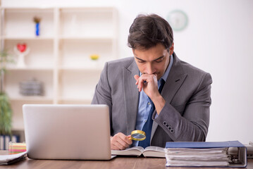 Young male employee working in the office