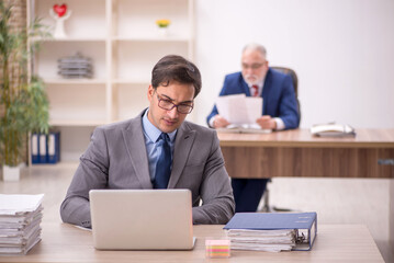 Two male colleagues sitting in the office