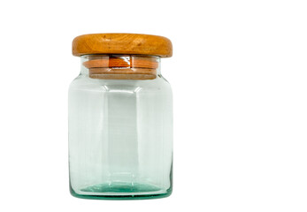 Isolated old glass jar with wooden lid. Vintage glass jar on white background, front view, empty space in the jar.