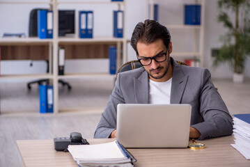 Young male employee working in the office