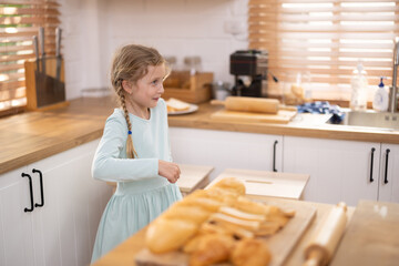 An enthusiastic girl makes a funny, quirky and grimacing face. Innocent children have a humorous and playful moment in their free time. Relaxing activities allow kids to develop positive emotions.