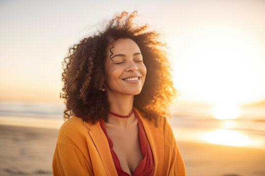 Serene woman with natural curly hair and a bright smile meditating on a beach at sunrise, generative ai