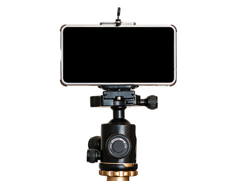 Mobile phone on a tripod, white isolated background. blank black screen. copyspace