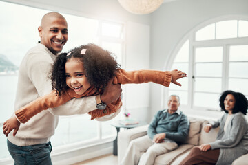 Family, flying and a father playing with his daughter in the living room of their home together during a visit. Children, energy and a man having fun with his girl while bonding in a house for love