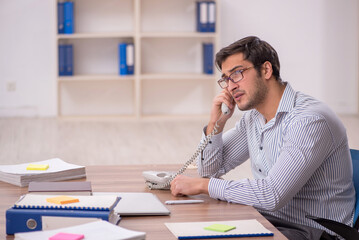 Young male employee working in the office