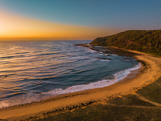 Fototapeta na wymiar Aerial sunrise seascape with beach and clear skies