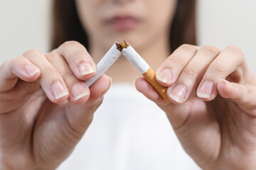 Close up hands of person refusing to smoke cigarette.