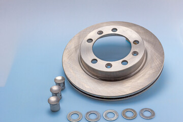 Car spare parts, brake systems and components on a white-blue milky background.