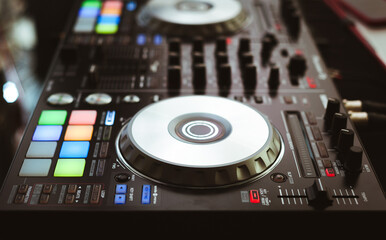 Fototapeta na wymiar DJ plays and mix music on digital midi controller