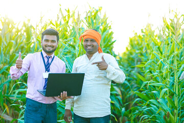 indian young farmer with agronomist, banker.