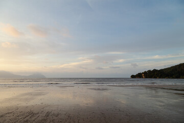 Bako national park, sea sandy beach, overcast, cloudy sunset, sky and sea, low tide. Vacation, travel, tropics concept, Malaysia