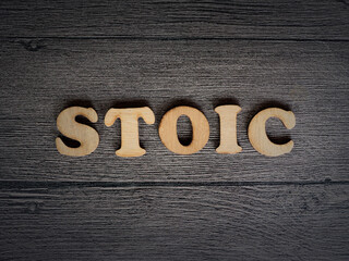 Stoicism word, stoic lifestyle concept, written on wooden lettering