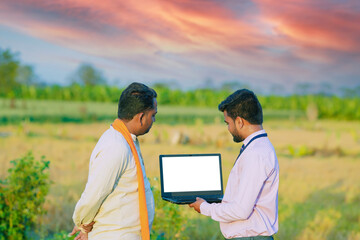 indian young farmer with agronomist, banker.
