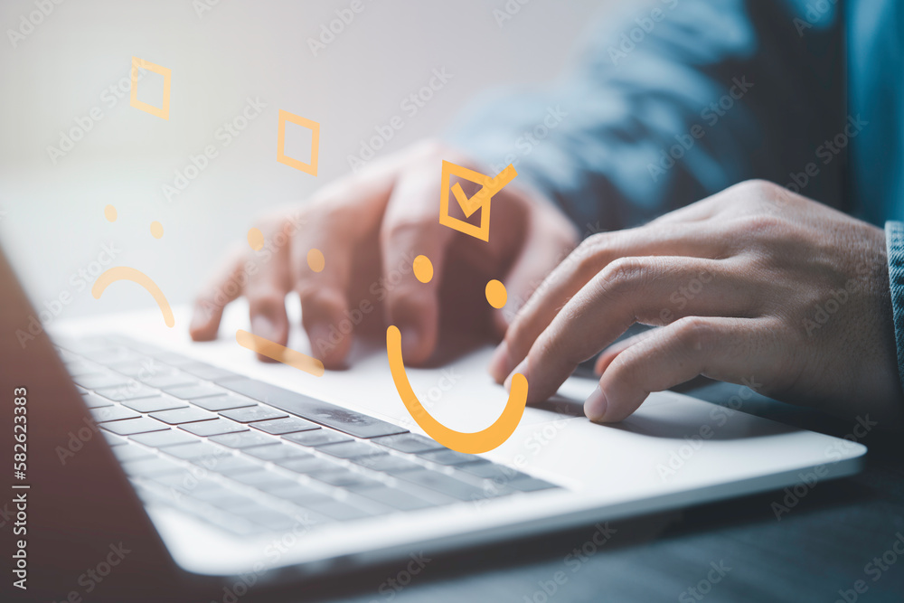 Poster Businessman use computer laptop to tick mark which select smiley face icon for client evaluation and customer satisfaction after use product and service concept.