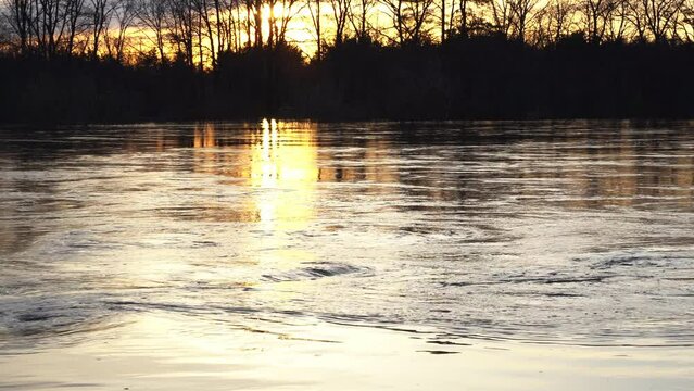 the flood of a wide river in high water at sunset, the concept of a screensaver and video wallpaper