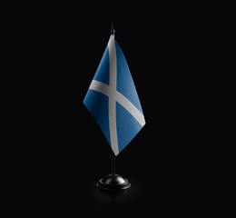 Small national flag of the Scotland on a black background