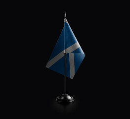 Small national flag of the Scotland on a black background