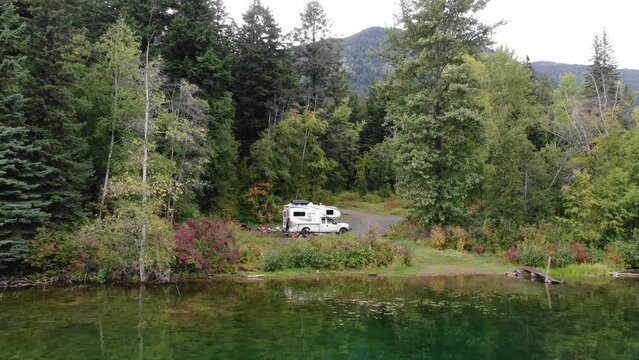 Aerial of RV camped next to beautiful forested lake in British Columbia Canada