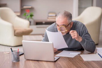 Old male employee working from home during pandemic