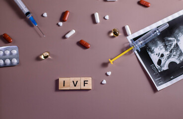 The abbreviation ECO is lined with wooden letters on a pink background. In vitro injection pen,...