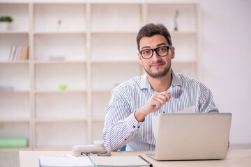 Young male employee working in the office