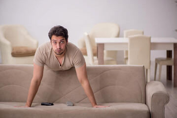 Fototapeta premium Young man sitting at home during pandemic