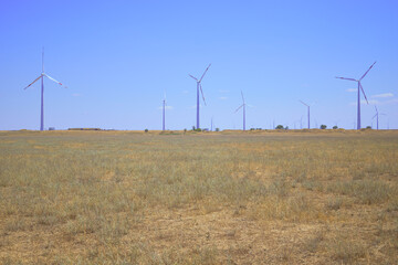 wind farm in the steppe against the blue sky