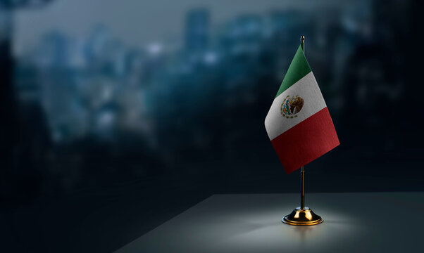 A small Mexico flag on an abstract blurry background