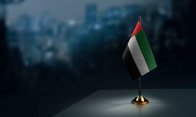 Small flags of the Arab Emirates on an abstract blurry background