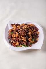 wok fried chicken cube meat with spicy hot dry chilli in Szechuan style on red white cloth asian chinese banquet halal menu