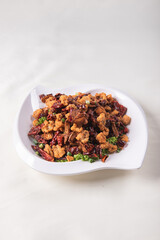 wok fried chicken cube meat with spicy hot dry chilli in Szechuan style on red white cloth asian chinese banquet halal menu