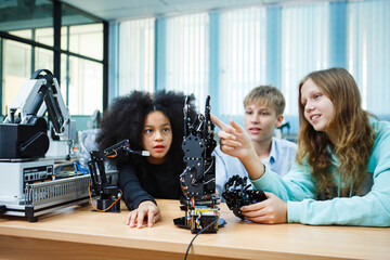 Kid-friendly experiments to education learning technology science robotics mechanics classes intelligent smart,Robotic Arm with remote control while testing his engineering wonder.
