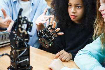 Kid-friendly experiments to education learning technology science robotics mechanics classes intelligent smart,Robotic Arm with remote control while testing his engineering wonder.