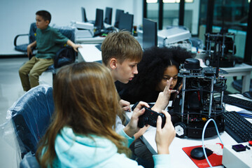 Kid-friendly experiments to education learning technology science robotics mechanics classes intelligent smart,Robotic Arm with remote control while testing his engineering wonder.