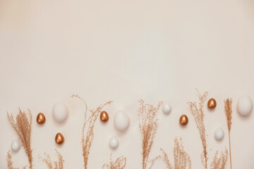 Top view of easter eggs colored with golden paint in differen patterns. White background. Copy space.