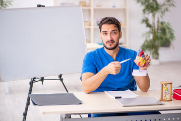 Young male doctor cardiologist working in the clinic