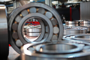 Finished products made of closed and open type bearings. The product is out of focus and the image is blurred. The concept of industry.General view of a large number of bearings.Selective focus.