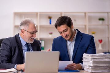 Two male colleagues working in the office